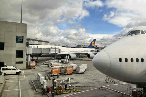 Two Boeing 747 planes viewed from a boarding gate at terminal 1 Mexico City Benito Juárez Airport.